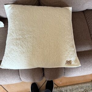 One UGG Cream Colored Pillow.